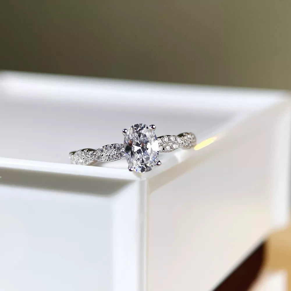 ring in silver featuring oval cut diamond and fitted fit