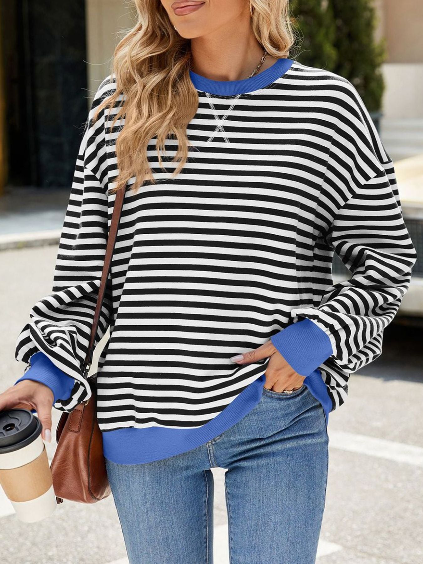 Striped crew neck sweatshirt with royal blue trim and cuffs.