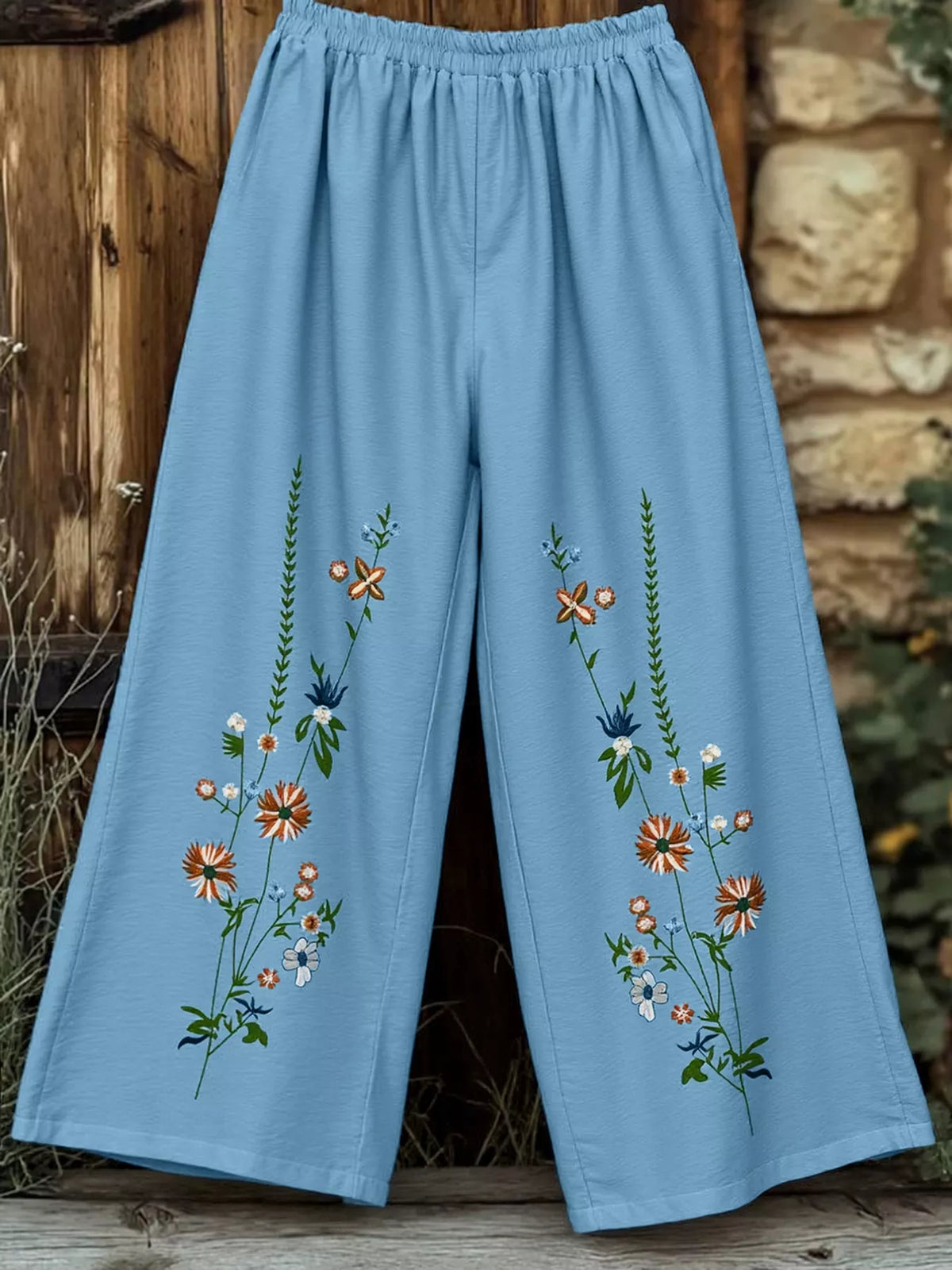 Floral wide-leg trousers in sky blue with embroidered flowers and a comfortable fit.