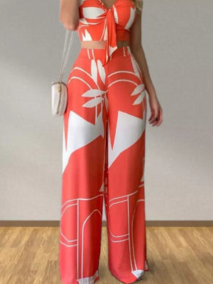 Orange tropical print V-neck crop top and wide-leg pants set with tie-front detail.