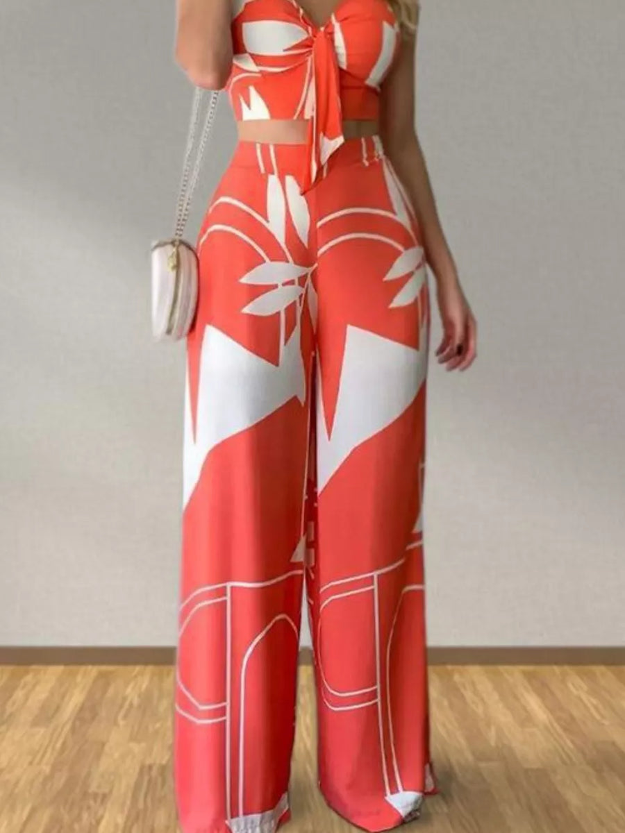 Orange tropical print V-neck crop top and wide-leg pants set with tie-front detail.