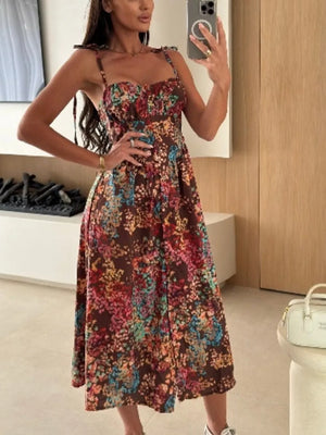 Floral tie-strap A-line midi dress in brown with a multicolor floral print.