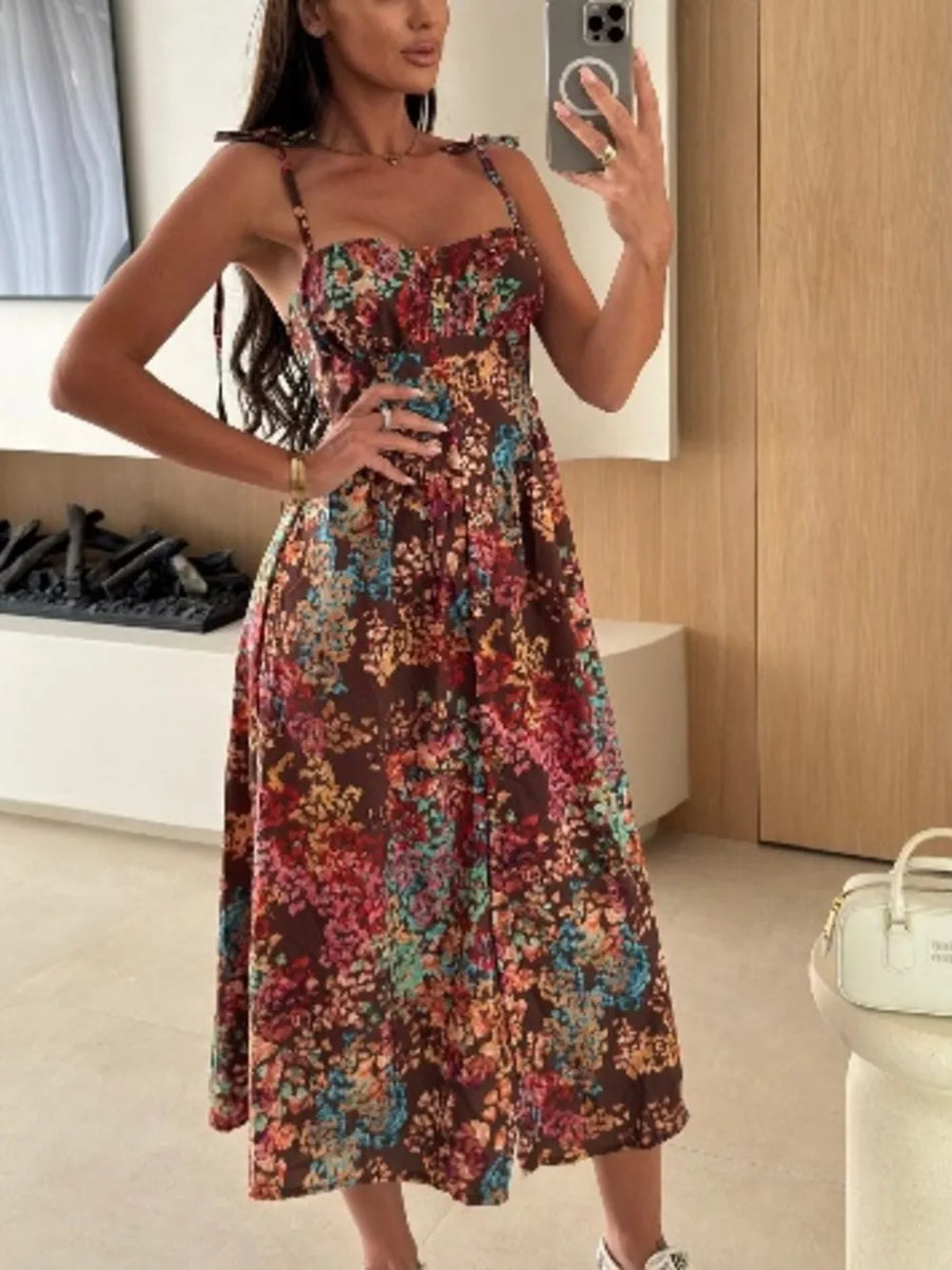 Floral tie-strap A-line midi dress in brown with a multicolor floral print.