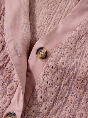Pink eyelet embroidered blouse with button front and tortoise shell buttons.