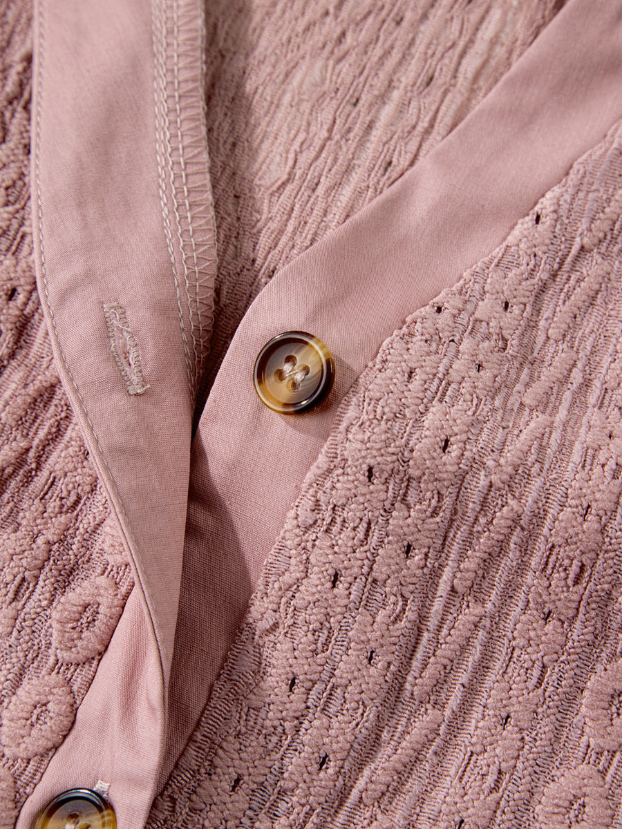 Pink eyelet embroidered blouse with button front and tortoise shell buttons.