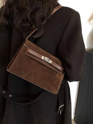 Brown suede shoulder bag with silver buckle detail and leather trim.