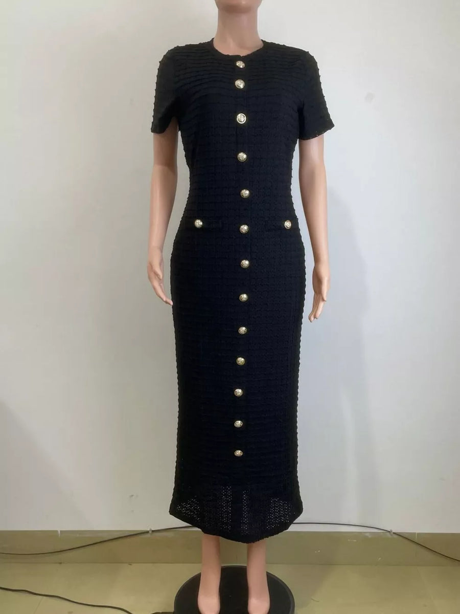 Black textured midi dress with gold buttons and short sleeves.