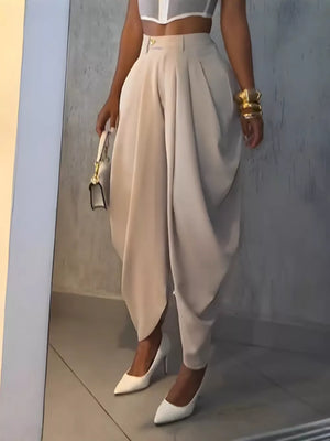 Light Khaki sculptural pleated high-waisted pants with a buttoned closure.