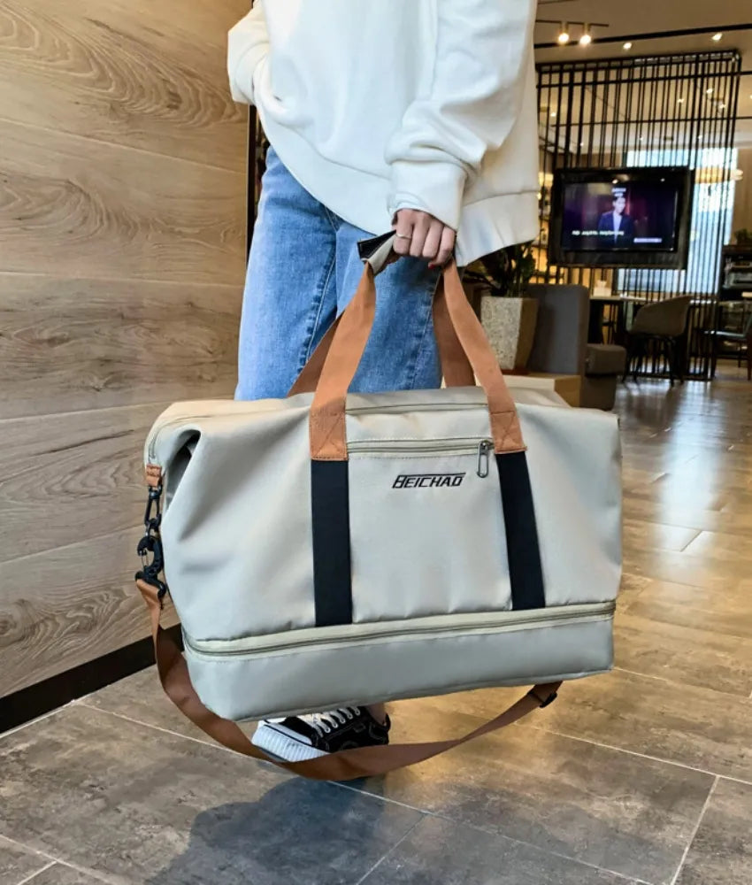 Dual-compartment weekender bag in Khaki with contrast brown and black straps.