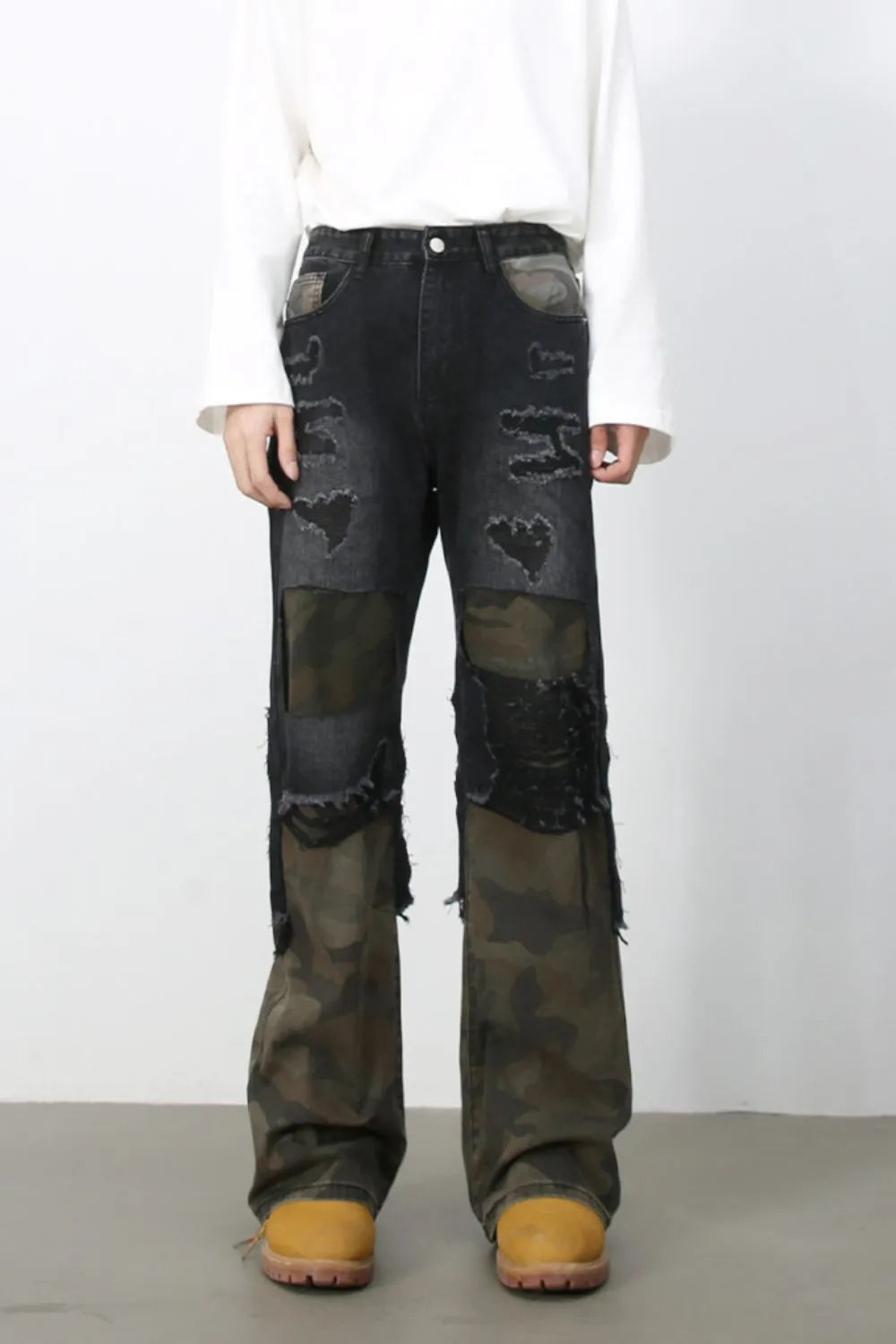 Distressed dark camo panel flare jeans with ripped details.