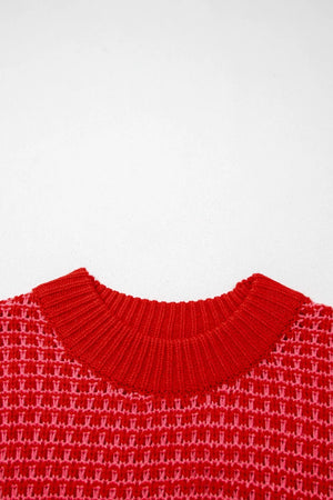 Red crew neck sweater with pink and red crochet detail knit pattern.