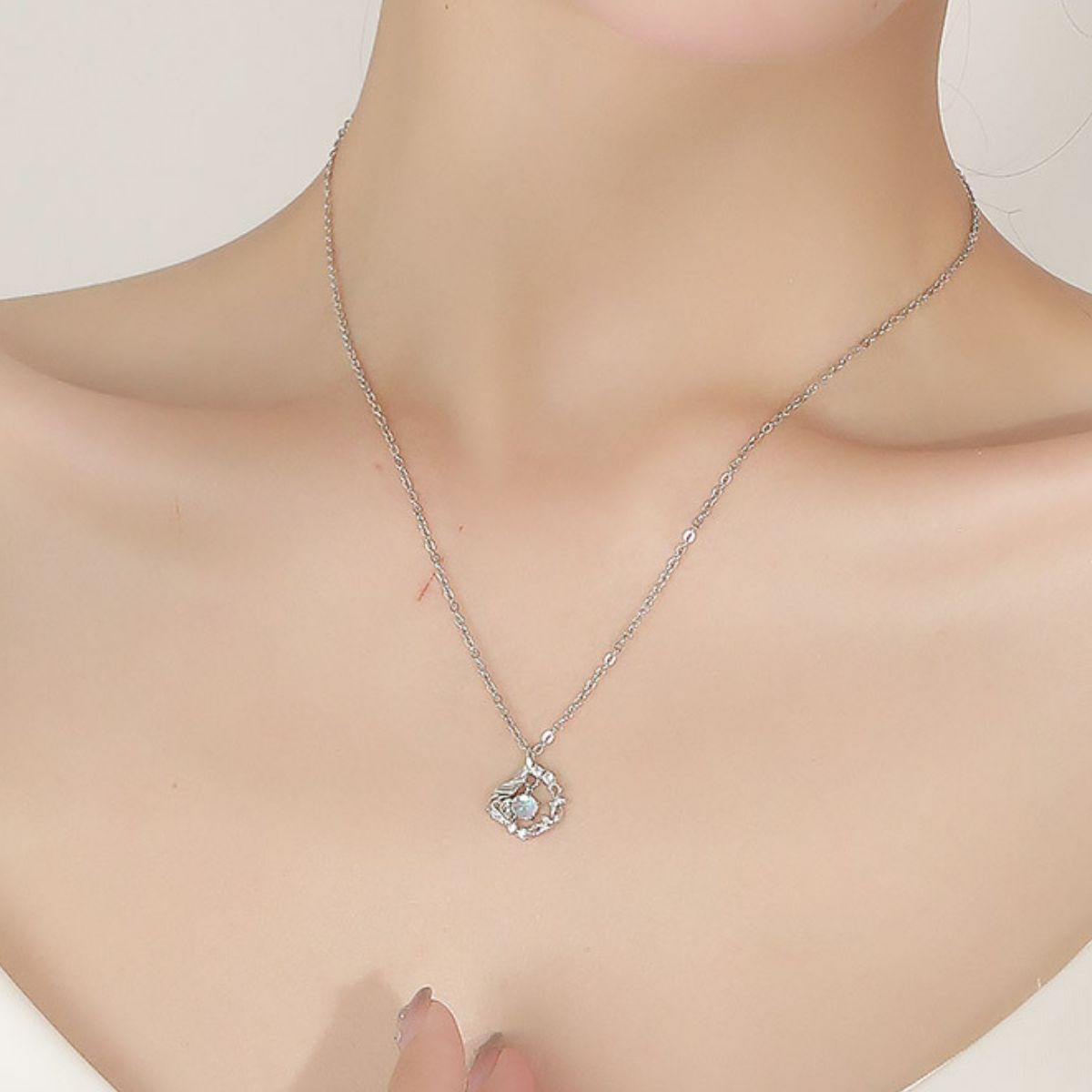 opalescent white necklace featuring pendant and floral