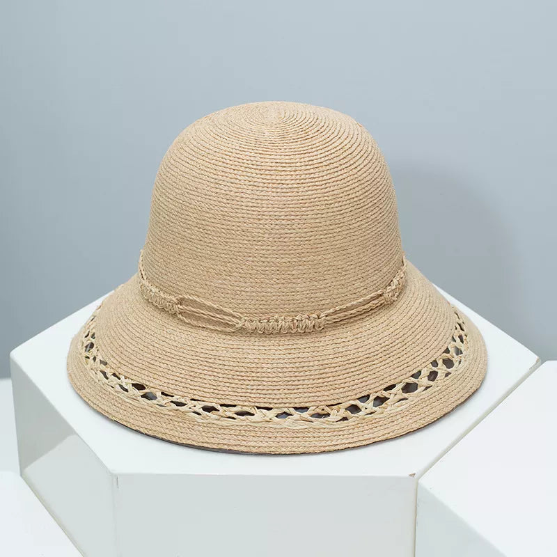 Woven straw bucket hat in Style B with twisted band and openwork brim detail.