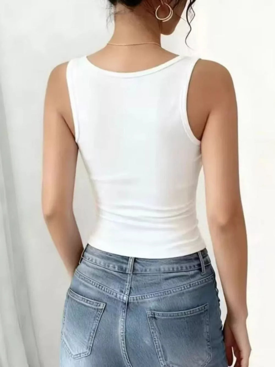 White ribbed V-neck tank top with delicate lace trim detail.