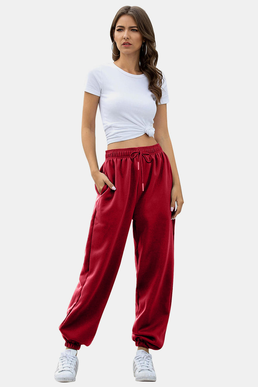 Slouchy gathered-cuff sweatpants in Deep Red with drawstring waist and pockets.
