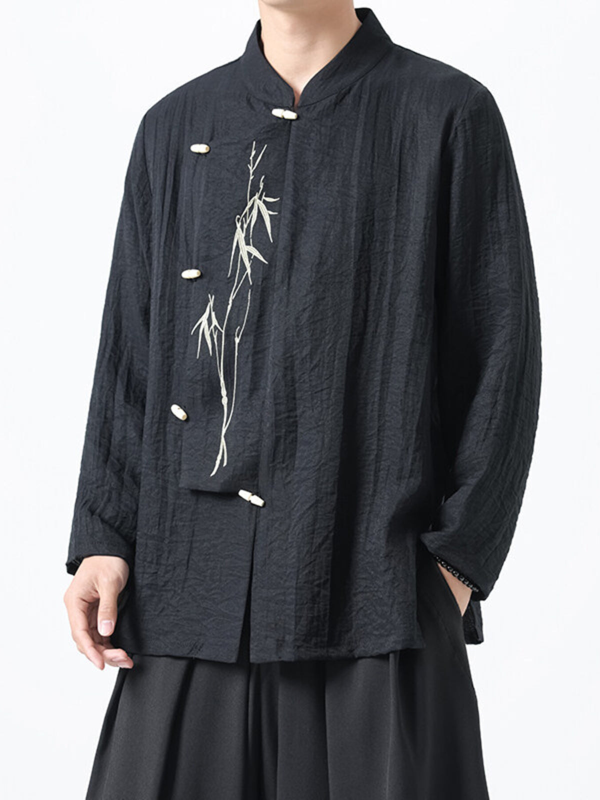 Black embroidered mandarin collar men's shirt with bamboo detail and button closure.