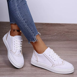 White matte finish lace-up sneakers with brogue detailing and gold accents.
