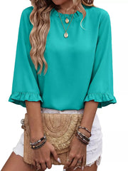 Teal ruffled mock neck shirt with half sleeves and ruffled cuffs.