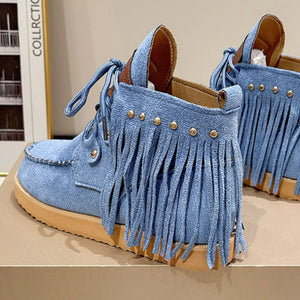 Blue denim ankle boots with fringe and gold stud details.
