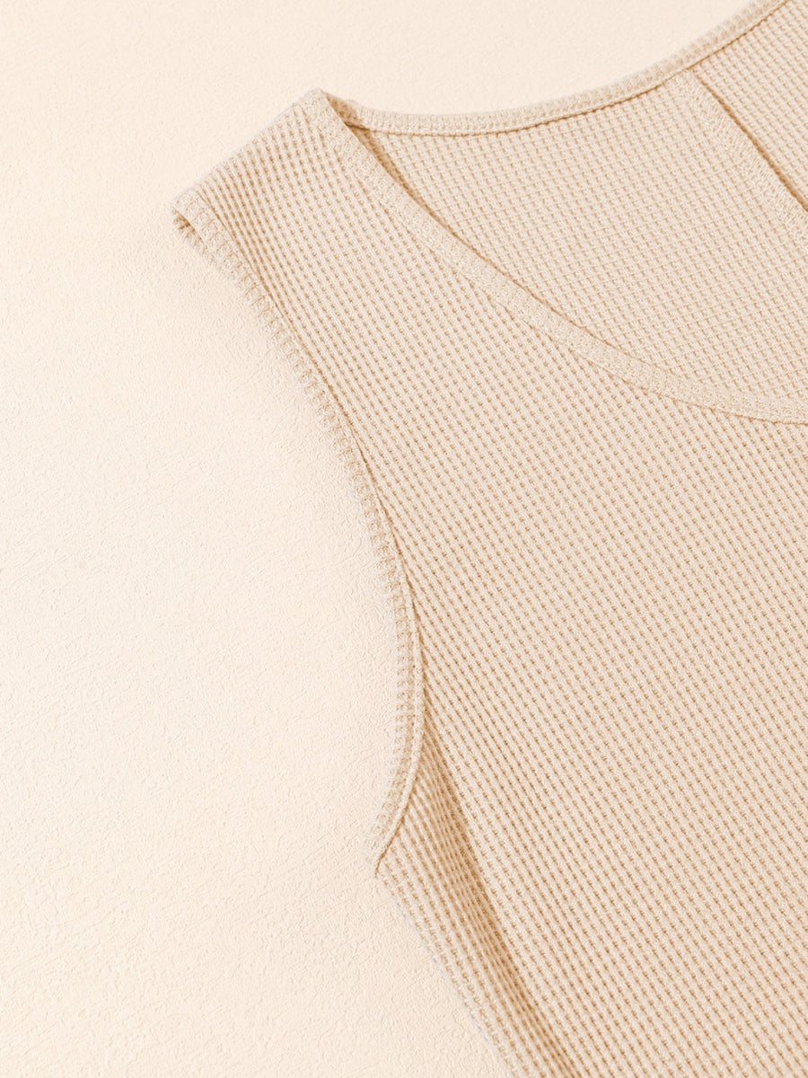 Camel waffle knit button-down romper detail with V-neck and cap sleeves.