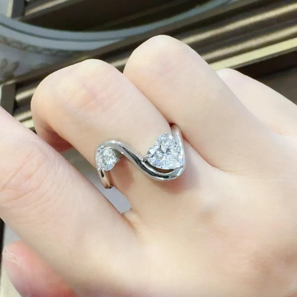 Silver heart-cut diamond infinity ring with two sparkling stones on a sterling silver band.