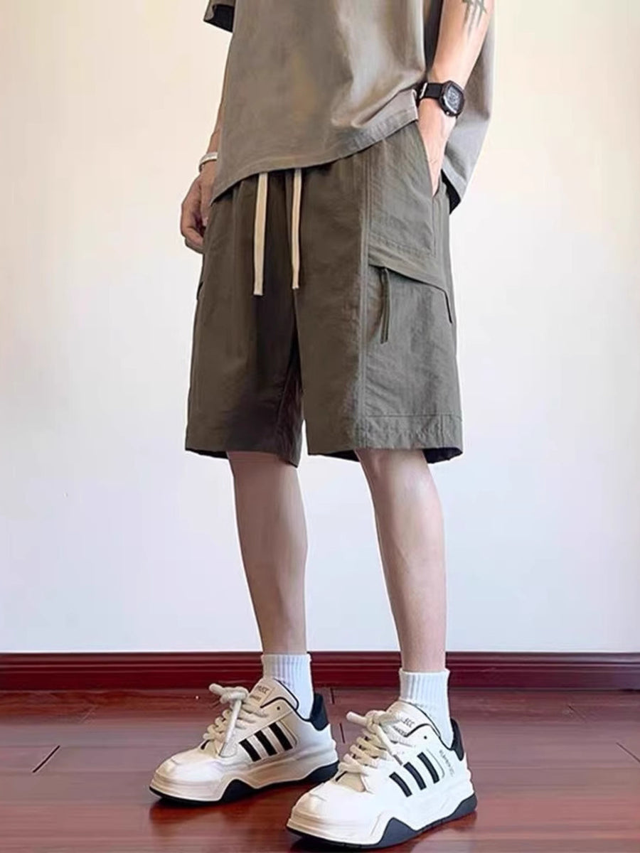 Men's green relaxed fit cargo shorts with drawstring waist and side pockets.