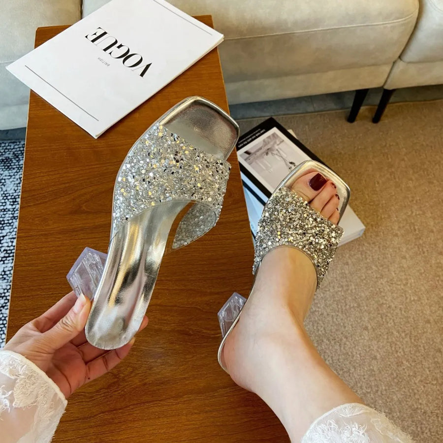 Silver glitter embellished lucite heel mules with square toe.