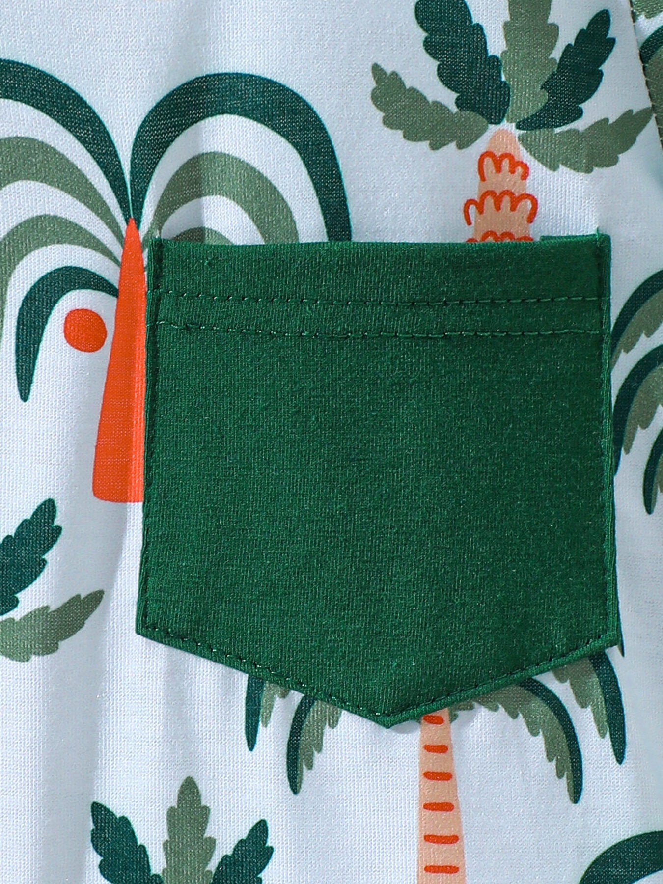 Baby tee and shorts set with tropical palm tree print and green pocket detail.