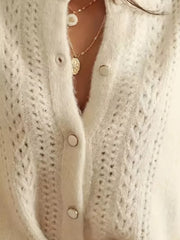 White eyelet detail button-down cardigan with silver buttons and layered necklaces.