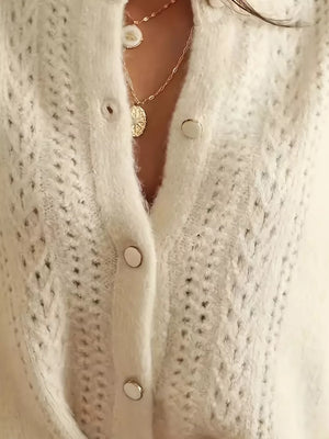 White eyelet detail button-down cardigan with silver buttons and layered necklaces.