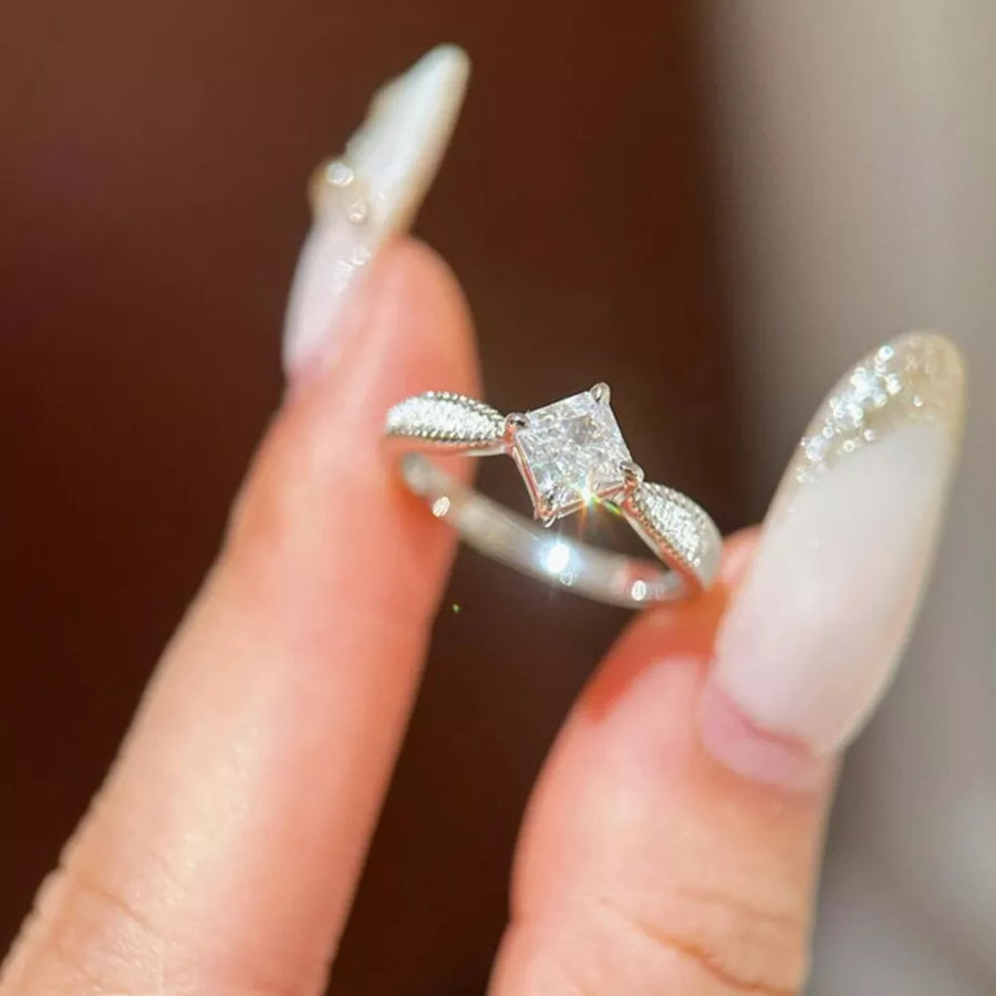 Sterling silver ring with princess cut moissanite and diamond accents