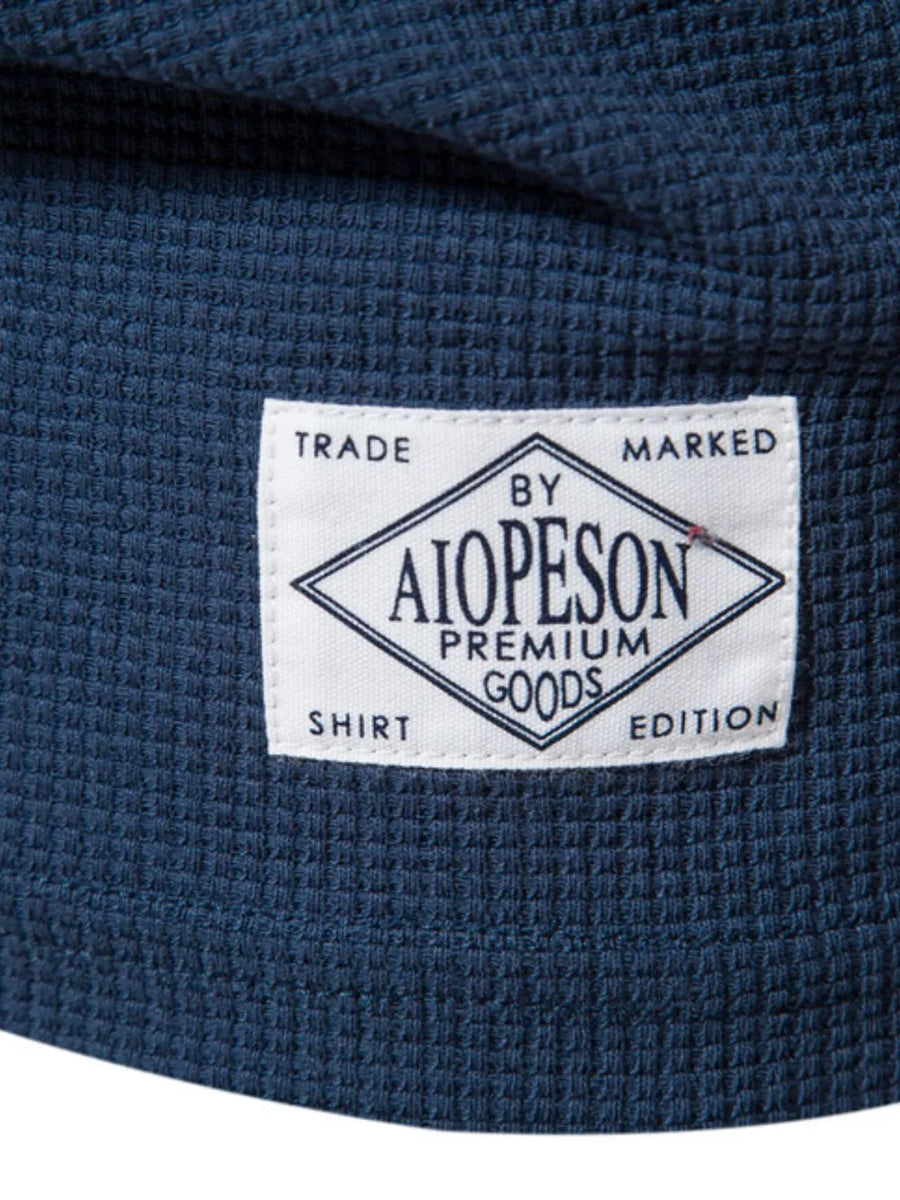 Navy textured crew-neck t-shirt knit with a white label detail.