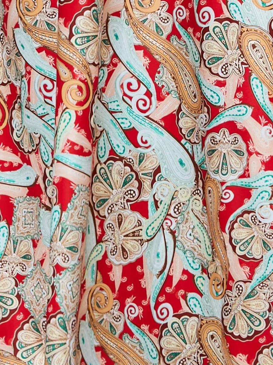 Chic floral midi dress in red with paisley pattern and spaghetti straps.