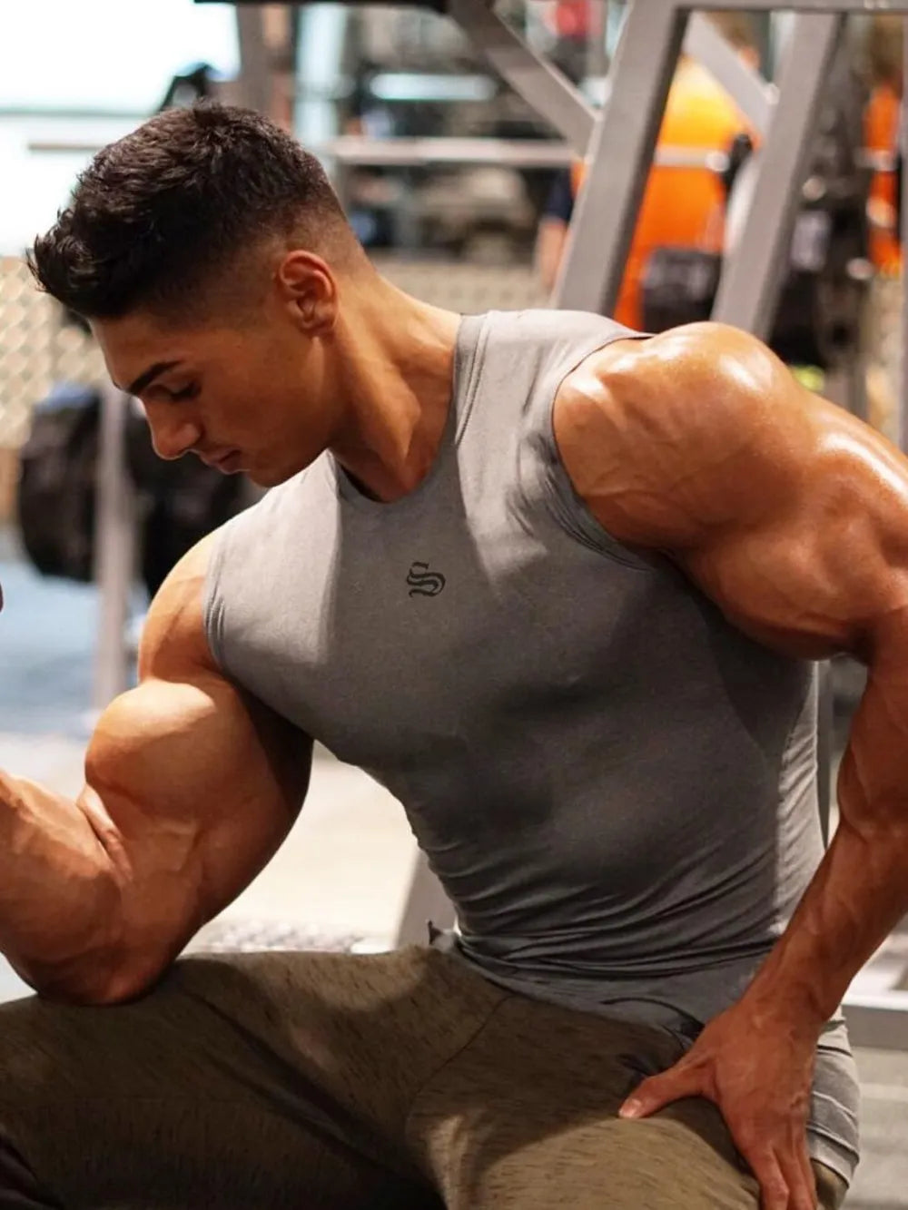 Gray performance fit muscle tank top with crew neck and subtle logo detail.