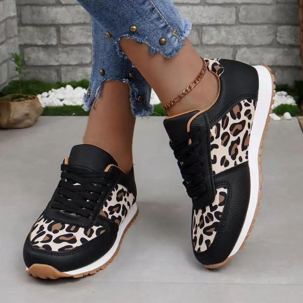 Leopard print panel runner sneakers in black with lace-up closure and white sole.