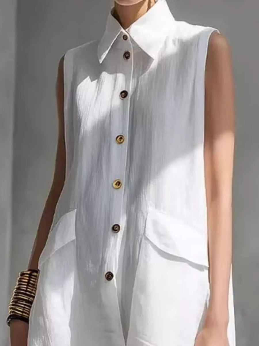 White sleeveless collared shirt dress with gold buttons and flap pockets