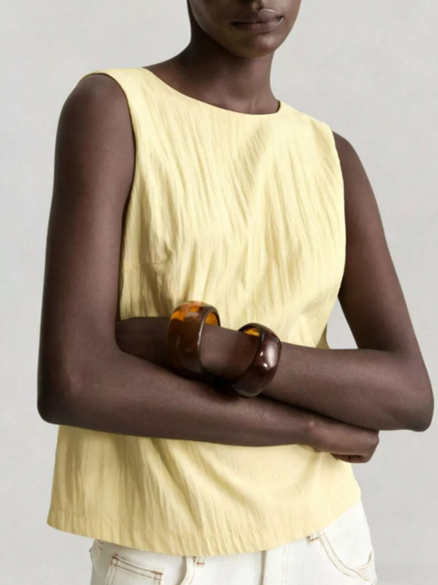 Yellow crinkle tank top with round neck and dart detail.