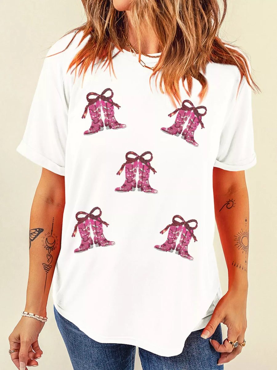 White graphic tee with sequined pink cowgirl boots print and bow details.