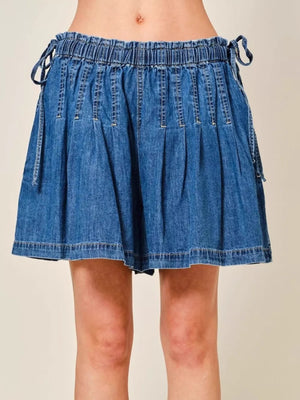 Medium blue denim shorts with ruched waist and drawstring ties.