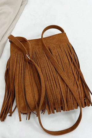 Brown suede crossbody bag with long fringe detail and adjustable strap.
