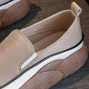 Khaki slip-on sneakers with a sculpted platform sole and white stripe detail.