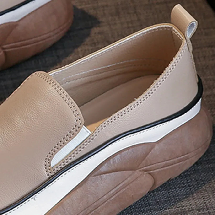 Khaki slip-on sneakers with a sculpted platform sole and white stripe detail.