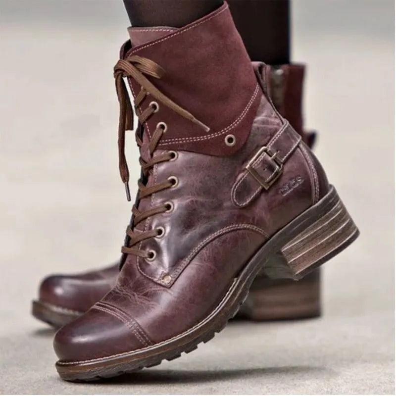 Burgundy combat boots with contrast cuff, laces, buckle strap, and distressed leather.