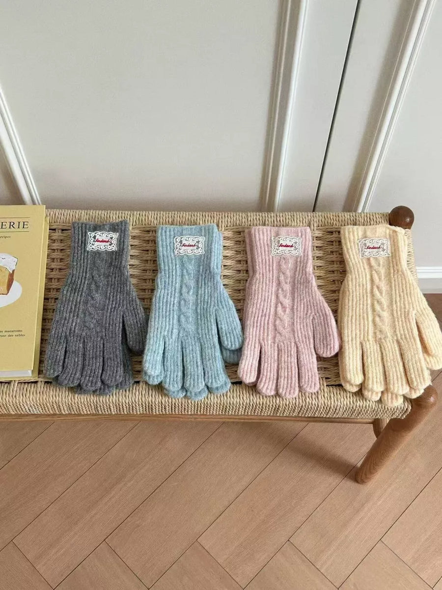 Luxurious cable knit gloves in gray, blue, pink, and yellow acrylic with decorative cuffs.