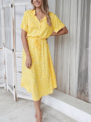 Yellow polka dot midi dress with tie waist, short sleeves, and collared neckline.