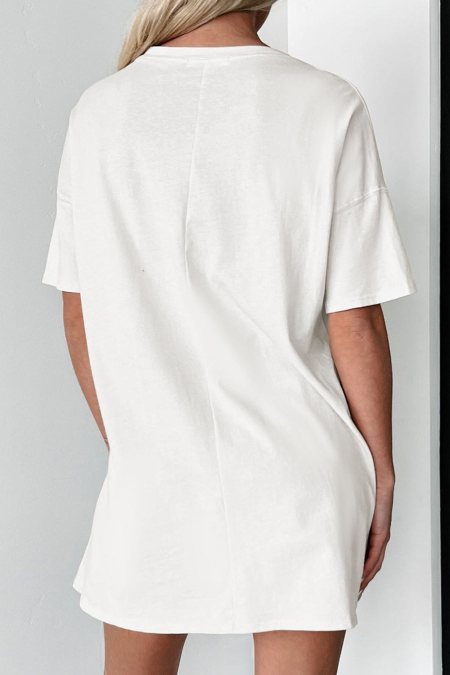 White cotton t-shirt dress with short sleeves and a relaxed silhouette.