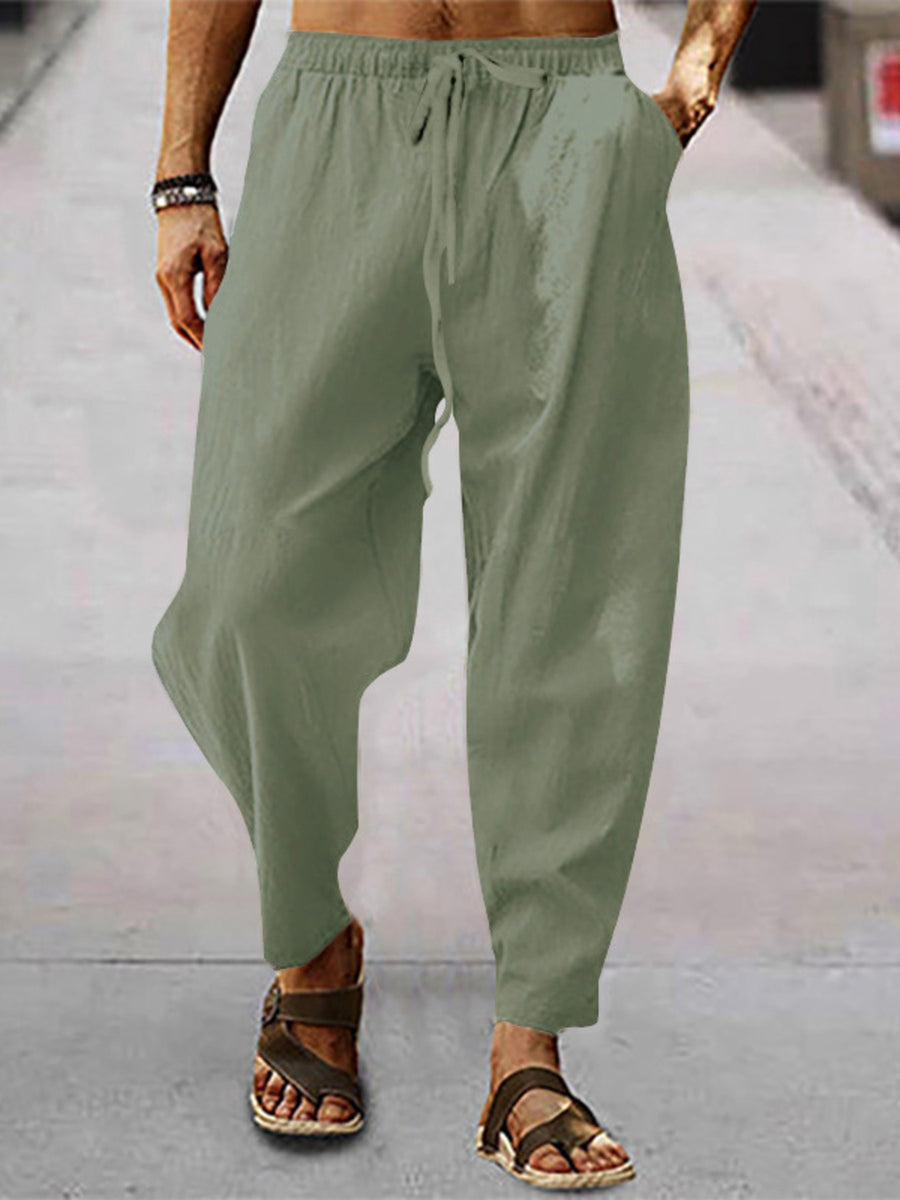Men's sage green drawstring wide leg sweatpants with pockets.