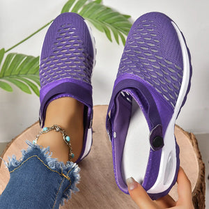 Purple knit sport clogs with heel strap and white sole, showing breathable mesh detail.