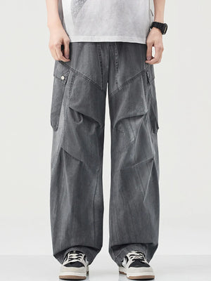 Loose fit grey cargo pants with drawstring and multiple pockets.