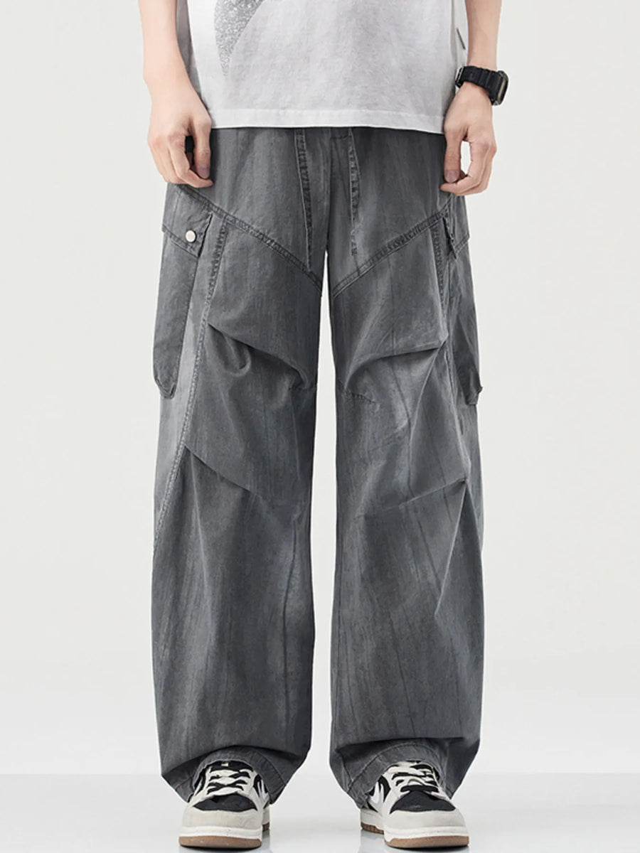 Loose fit grey cargo pants with drawstring and multiple pockets.
